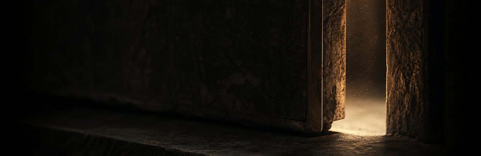 A dark stone threshold with a narrow warm line of light, a private invitation rather than a shop.