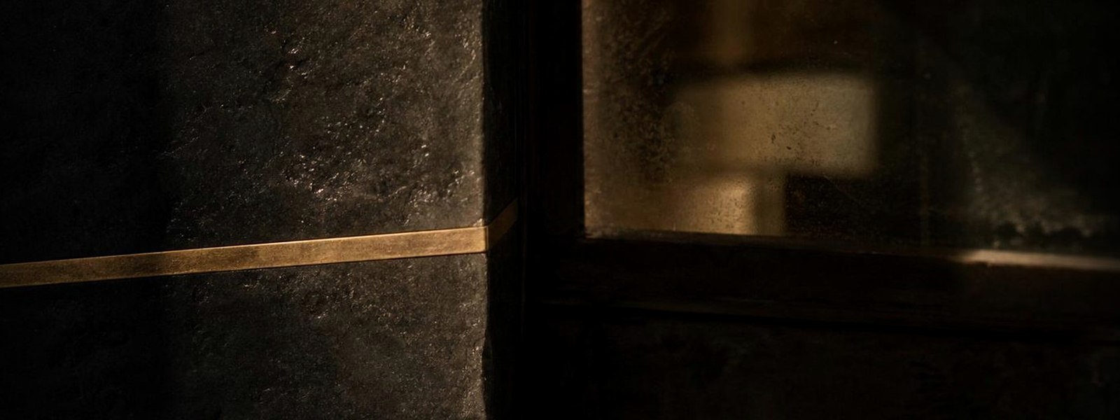 A dark private cellar with a bottle held in documented custody, on how a bottle is chosen and kept